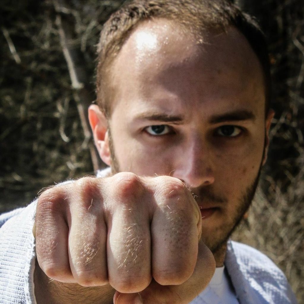 antonio holding his fist in front of his face